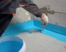 Someone waterproofing a home’s foundation in the Green Bay, Wisconsin area.