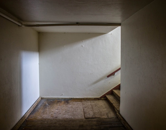 A bowing wall and floorboards in a Green Bay, Wisconsin basement.