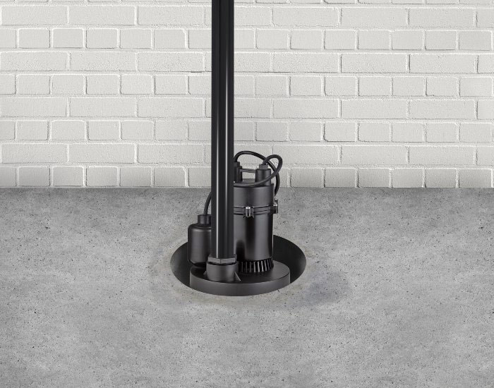 A black sump pump in a concrete floor basement located Green Bay, Wisconsin.