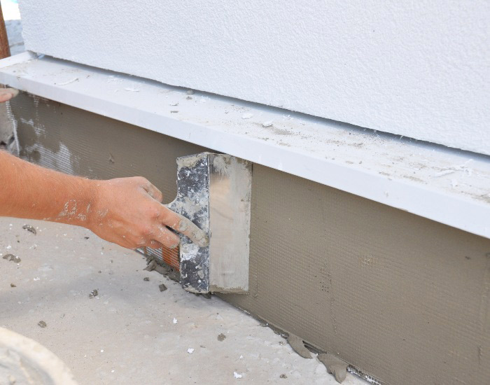 A worker seals a home’s foundation in Green Bay, Wisconsin.