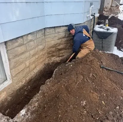 A professional waterproofs the exterior of a house in Pulaski, WI