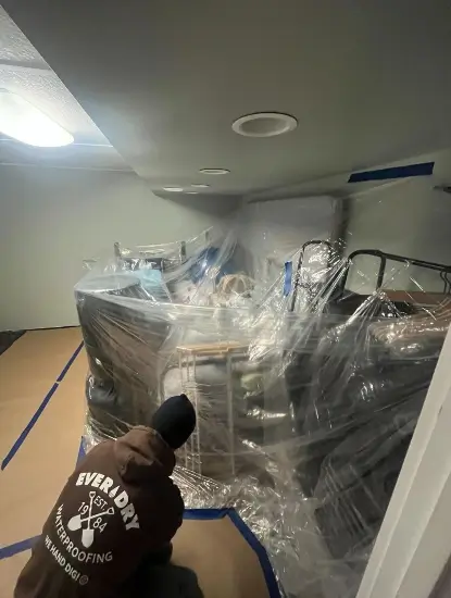 Workers prepping the basement for waterproofing in Rothschild, WI